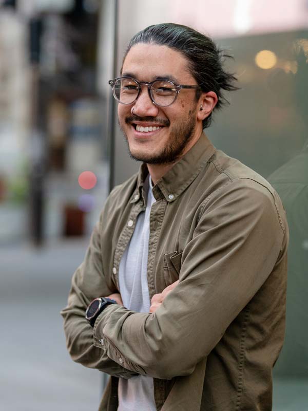 Man smiling having dealt with and ovecrome CPTSD.