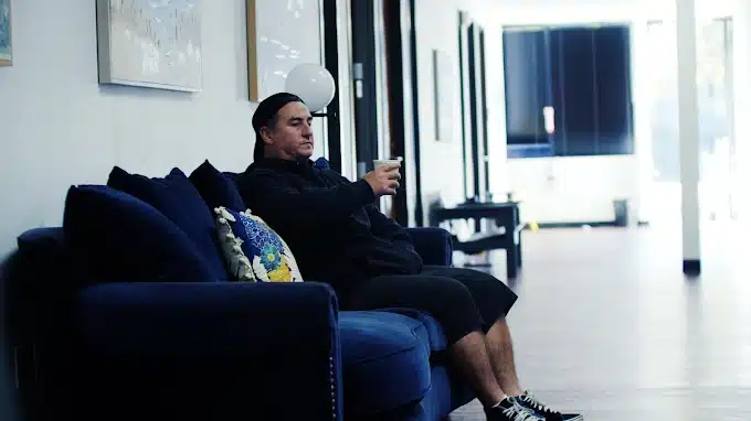 Person contemplating when to consider IOP for mental health treatment in comfortable therapy setting