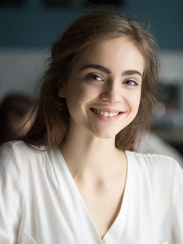 Young woman smiling, representing successful treatment for Dependent Personality Disorder