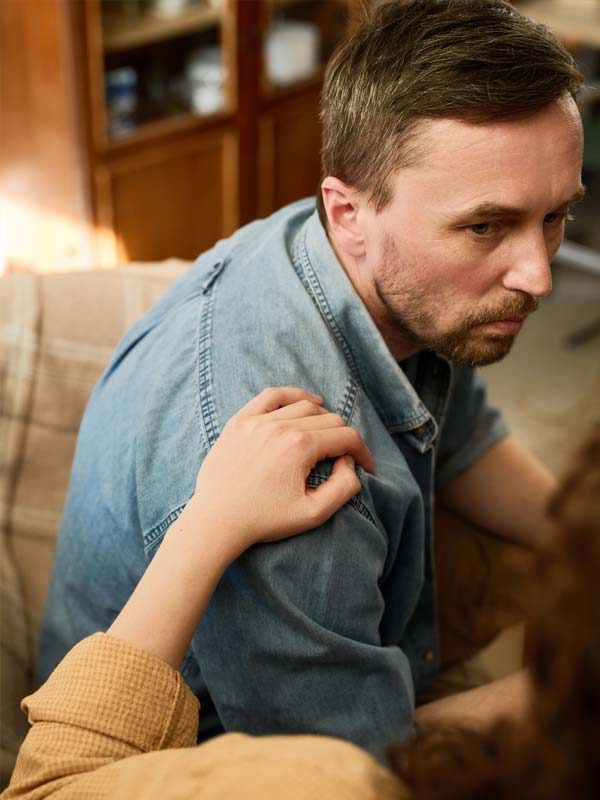 Man recovering from Psychosis sitting with a therapist.