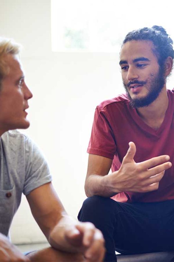 iop-for-men-discussion Two guys discussing DBT thereapy.